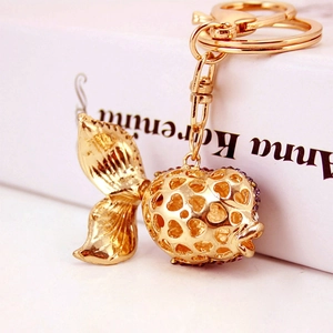 Golden goldfish keychain with hollow heart pattern and purple rhinestones accessory