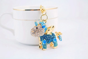 Detailed view of golden unicorn keychain with blue and white rhinestones and lobster clasp
