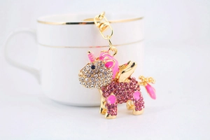 Detailed view of unicorn keychain with sparkling pink rhinestones and golden hardware