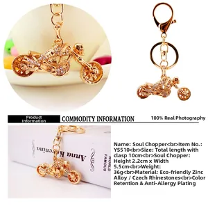 Macro detail of motorcycle keychain with rhinestones and lobster clasp on white dish