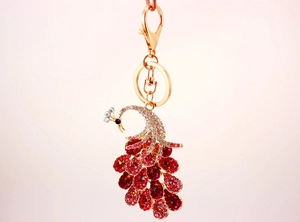 Detail of colorful crystal peacock keychain with pink rhinestones and gold metal lobster clasp