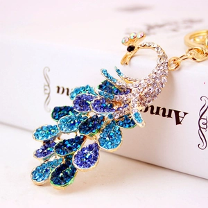 Colorful peacock keychain with blue gradient rhinestones on golden metal base