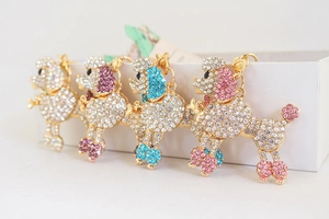 Detail of poodle keychains with colorful rhinestones in pink, blue, purple and white
