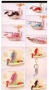 Close-up of rhinestone dolphin keychains in multiple colors with metal lobster clasps