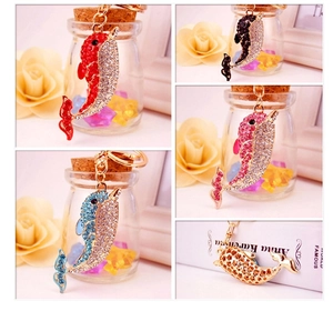 Macro detail of rhinestone dolphin keychains in multiple colors with metal lobster clasps