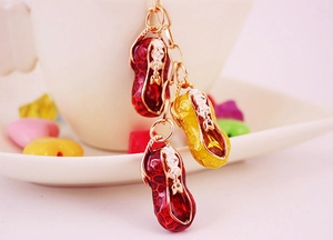 Close-up of enamel peanut charms with leopard patterns on a white coffee cup edge