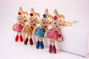 Detailed close-up showing four rhinestone rabbit keychains in various vibrant colors