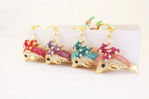 Detailed set of four rhinestone dolphin keychains in assorted vibrant gradient colors