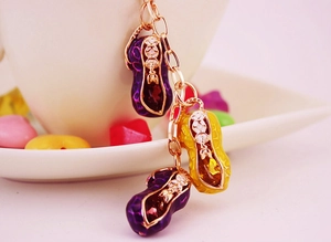 Detail view of colorful peanut charms with enamel texture on a metallic keychain