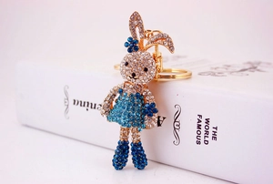 Detailed view of a gold alloy rabbit keychain featuring sparkling blue and white rhinestones