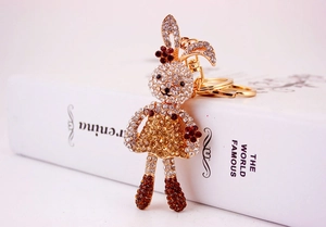 Close-up of cute cartoon rabbit keychain with sparkling rhinestones and golden lobster clasp