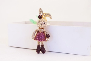 Close-up of cute cartoon rabbit keychain with purple rhinestones and golden alloy base