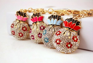 Detail view of colorful lucky bag keychains with sparkling rhinestones and enamel craft