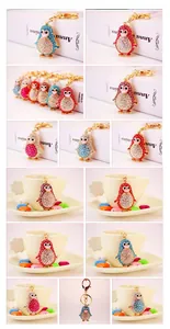Close-up of sparkling rhinestone penguin keychains in various vibrant colors with gold clasp