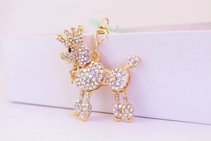 Close-up of golden poodle keychain with sparkling crystals and a crown detail