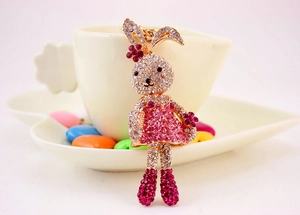 Close-up of cute cartoon rabbit keychain with sparkling white and pink rhinestones