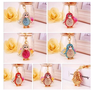 Detail view of colorful rhinestone penguin keychains in various vibrant crystal finishes