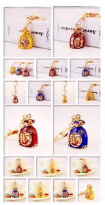 Detail of metal money bag keychain with colorful enamel coating and Fortune character