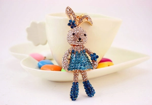 Detailed macro view of cute cartoon rabbit keychain with blue and white rhinestones