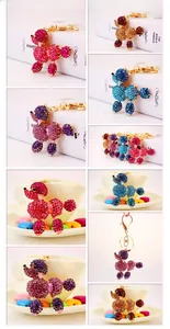 Detail view of crystal poodle keychains in various colors with golden metal plating