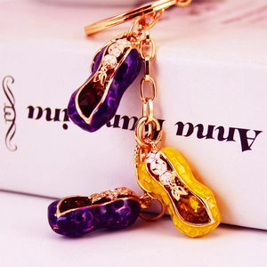 Exquisite peanut keychain with purple and yellow enamel pendants on a gold chain
