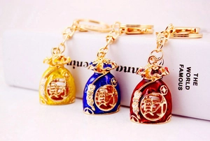 Detail of Chinese lucky bag keychain with enamel finish and sparkling crystal accents