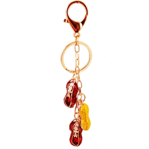Peanut keychain with red and yellow enamel pendants on a gold plated keyring