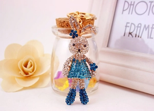 Close-up of cute rabbit keychain with blue rhinestones and gold alloy details