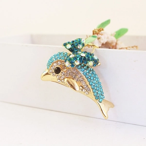 Sparkling dolphin keychain with blue rhinestones and gold-tone finish on a gift box