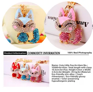 Detail showing crystal-encrusted fox keychains in red, blue, and pink zinc alloy