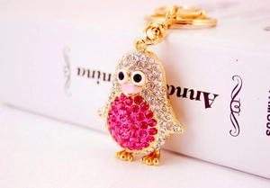 Detailed close-up of crystal penguin keychain with pink rhinestones and gold plating