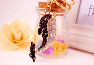 Close-up of golden dolphin keychain with sparkling rhinestones and durable hardware