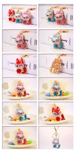 Close-up of cute cartoon fox keychains with red, pink and blue rhinestone crystals