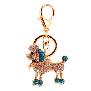 Cute poodle keychain with white and blue crystals on a golden metal dog bag pendant