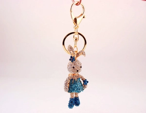 Close-up of cute cartoon long-legged bunny keychain with sparkling blue rhinestones