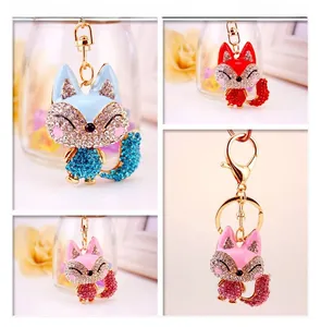 Detailed macro view of sparkling crystal fox keychains in four vibrant colors with gold clips