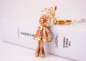 Detailed macro view of the gold-plated metal bunny keychain with sparkling rhinestones