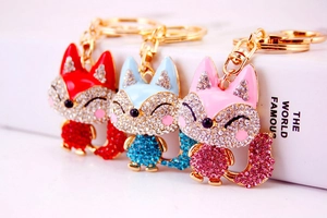 Macro shot of fox keychains in red, light blue, and pink with sparkling rhinestones