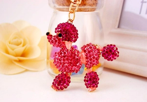 Detail of rose red poodle keychain with sparkling rhinestones and golden hardware