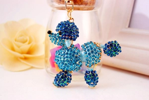 Detail of poodle keychain with sparkling blue rhinestones and gold-tone metal plating