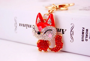 Detail of cute fox keychain with red and white rhinestones and golden metal lobster clasp
