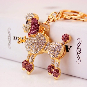 Porte-clés caniche charmant avec strass blancs et violets sur base en alliage doré