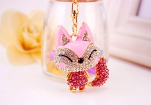 Detail of fox keychain with sparkling pink rhinestones and golden metal hardware