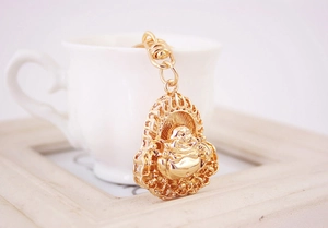 Detailed close-up of golden Maitreya Buddha keychain with intricate floral patterns