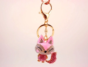 Close-up of pink fox keychain with sparkling crystals and golden alloy lobster clasp