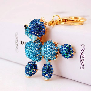Charming golden metal poodle keychain with deep blue rhinestones for women's bags