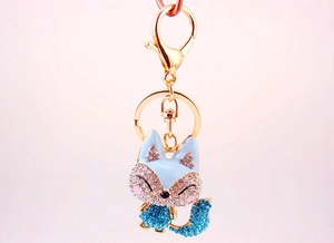 Detail of blue rhinestone fox keychain with gold metal clasp and lobster hook