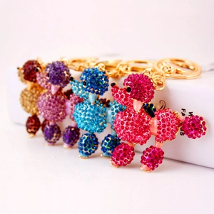 Sparkling crystal poodle keychains in pink, blue, purple and red-brown crystal finish