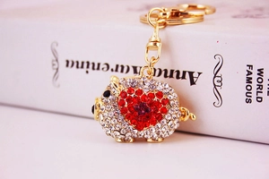 Detailed macro shot of pig keychain with gold alloy frame and sparkling heart crystals