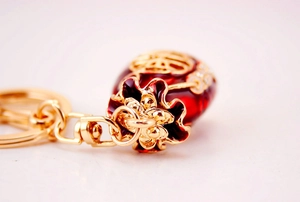 Macro view of Chinese lucky money bag keychain with red enamel finish and gold Fu character